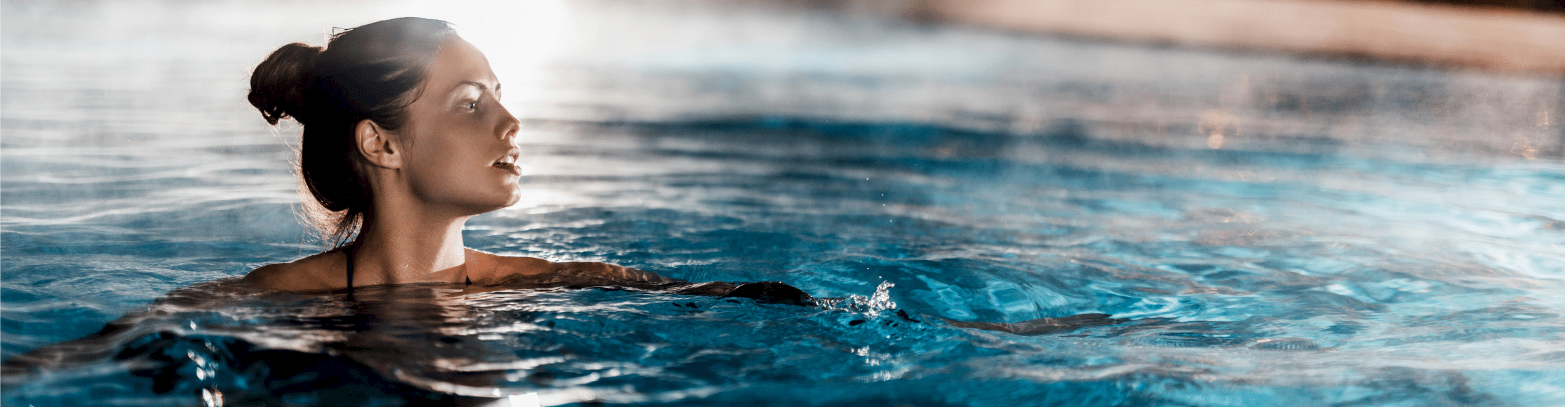woman swimming heated NUSPA pool